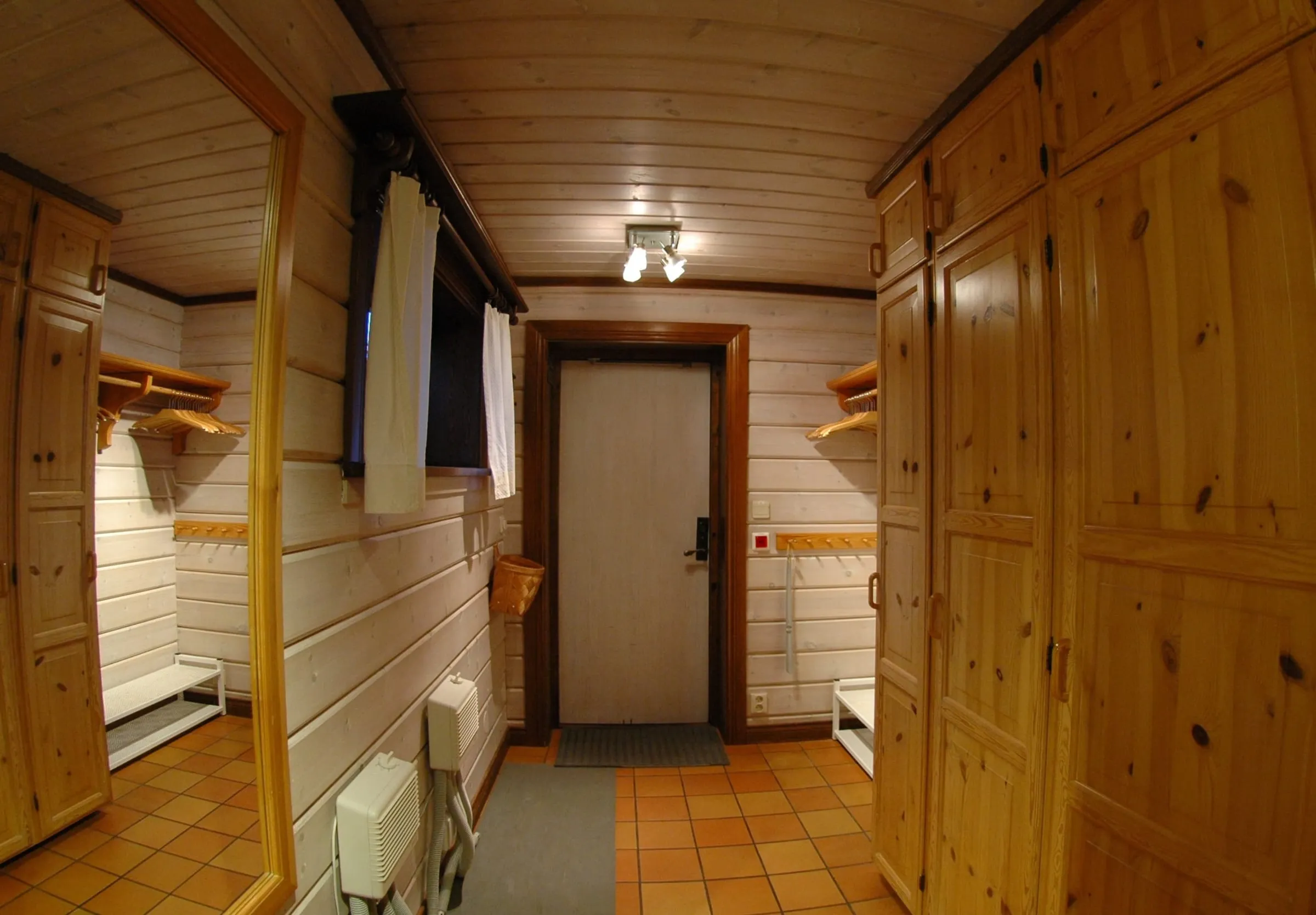 The entrance hall is equipped with a plentiful set of wardrobes and wall cupboards ...